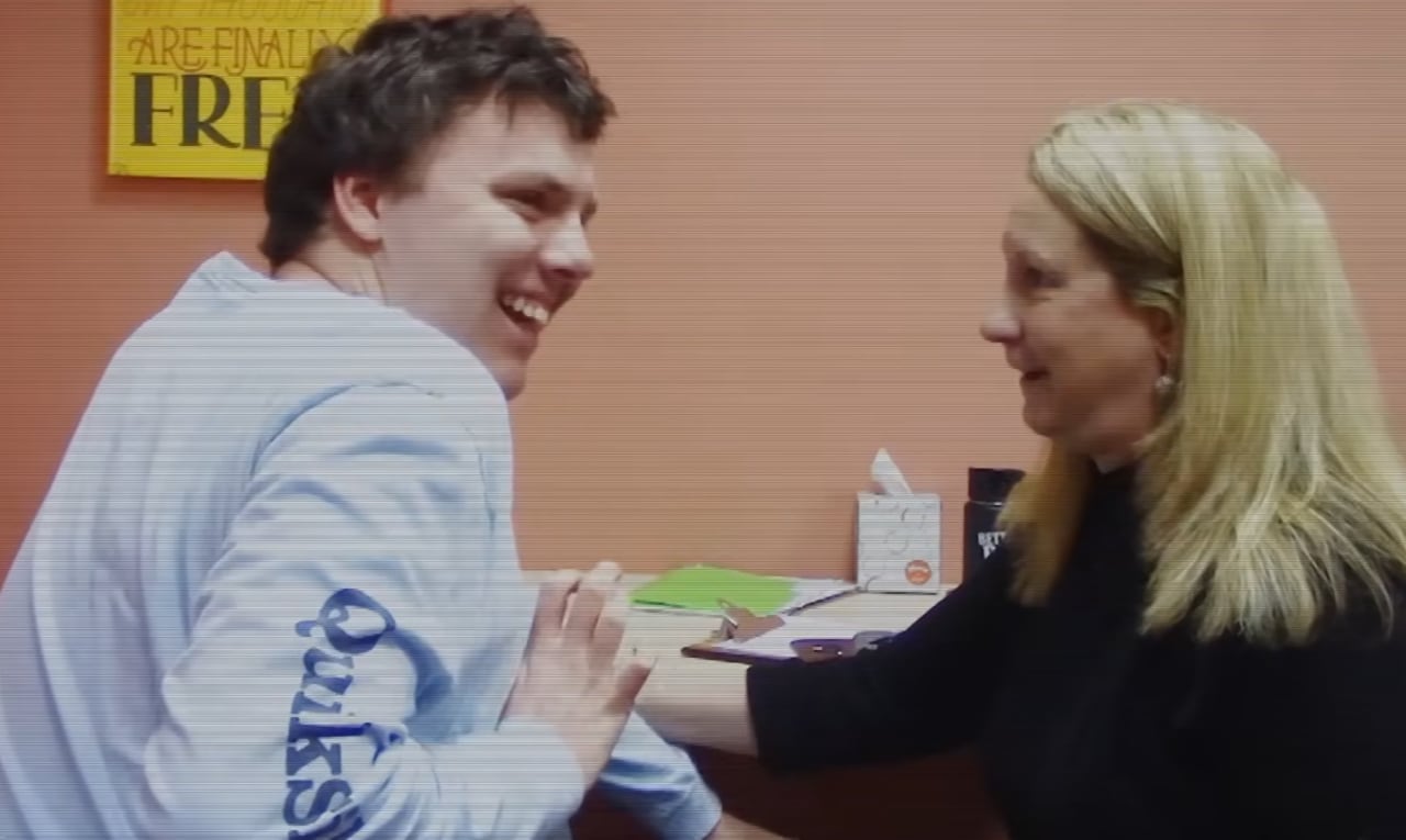 Jamie laughing with his dad during a Spelling to Communicate session